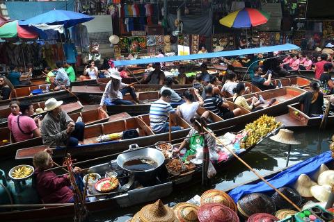 Floating market. The Thai for "floating market" is "ตลาดน้ำ".