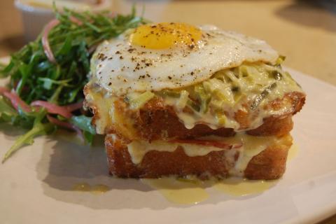 Toasted cheese and ham sandwich with a fried egg on top. The French for "toasted cheese and ham sandwich with a fried egg on top" is "croque-madame". Toasted cheese and ham sandwich with a fried egg on top. The French for "toasted cheese and ham sandwich with a fried egg on top" is "croque-madame".