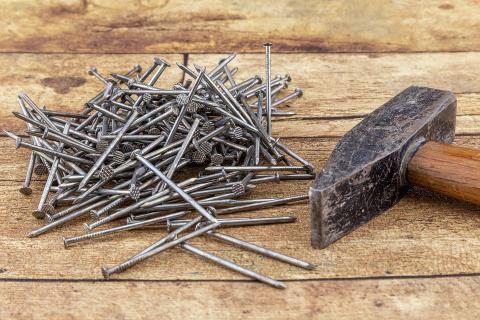 A hammer and a pile of nails. The Thai for "a hammer and a pile of nails" is "ค้อนและกองตะปู". A hammer and a pile of nails. The Thai for "a hammer and a pile of nails" is "ค้อนและกองตะปู".