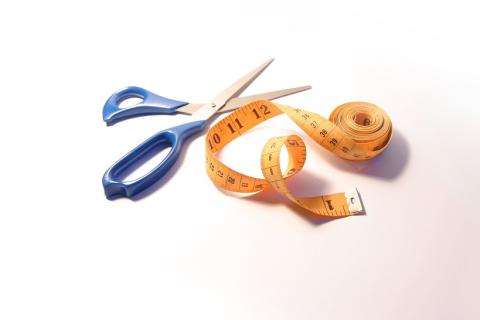 A pair of scissors and a tape measure. The Thai for "a pair of scissors and a tape measure" is "กรรไกรและสายวัด". A pair of scissors and a tape measure. The Thai for "a pair of scissors and a tape measure" is "กรรไกรและสายวัด".