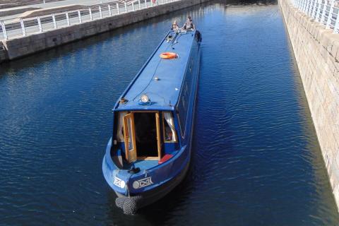 A blue boat in a canal. The Thai for "a blue boat in a canal" is "เรือสีน้ำเงินในคลอง". A blue boat in a canal. The Thai for "a blue boat in a canal" is "เรือสีน้ำเงินในคลอง".