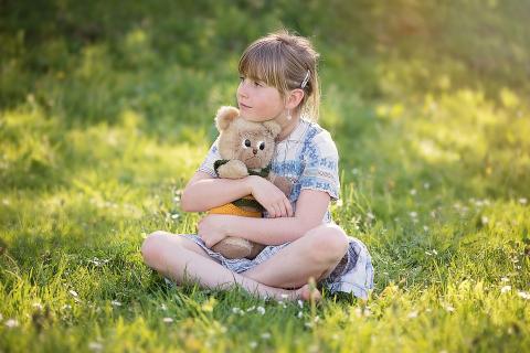 A girl and a teddy bear in a meadow. The Thai for "a girl and a teddy bear in a meadow" is "เด็กหญิงและตุ๊กตาหมีบนทุ่งหญ้า". A girl and a teddy bear in a meadow. The Thai for "a girl and a teddy bear in a meadow" is "เด็กหญิงและตุ๊กตาหมีบนทุ่งหญ้า".