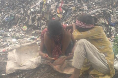 Two girls sitting on a pile of garbage. The Thai for "two girls sitting on a pile of garbage" is "เด็กหญิงสองคนนั่งบนกองขยะ". Two girls sitting on a pile of garbage. The Thai for "two girls sitting on a pile of garbage" is "เด็กหญิงสองคนนั่งบนกองขยะ".