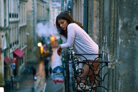 A women smokes on the balcony. The Thai for "a women smokes on the balcony" is "ผู้หญิงสูบบุหรี่บนระเบียง". A women smokes on the balcony. The Thai for "a women smokes on the balcony" is "ผู้หญิงสูบบุหรี่บนระเบียง".