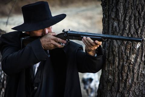 A man in black with a rifle. The Thai for "a man in black with a rifle" is "ชายชุดดำกับปืนยาว". A man in black with a rifle. The Thai for "a man in black with a rifle" is "ชายชุดดำกับปืนยาว".