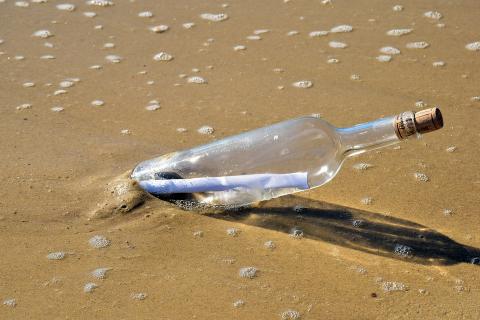 A message in a bottle at the beach. The Thai for "a message in a bottle at the beach" is "ข้อความในขวดที่ชายหาด". A message in a bottle at the beach. The Thai for "a message in a bottle at the beach" is "ข้อความในขวดที่ชายหาด".
