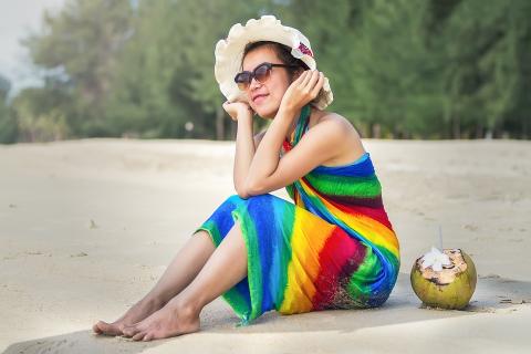 A woman in a rainbow dress with a coconut. The Thai for "a woman in a rainbow dress with a coconut" is "ผู้หญิงในชุดสีรุ้งกับมะพร้าวหนึ่งลูก". A woman in a rainbow dress with a coconut. The Thai for "a woman in a rainbow dress with a coconut" is "ผู้หญิงในชุดสีรุ้งกับมะพร้าวหนึ่งลูก".
