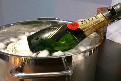 A bottle of champagne in an ice bucket. The Thai for "a bottle of champagne in an ice bucket" is "ขวดแชมเปญในถังน้ำแข็ง". A bottle of champagne in an ice bucket. The Thai for "a bottle of champagne in an ice bucket" is "ขวดแชมเปญในถังน้ำแข็ง".