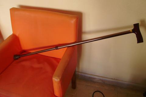 A cane on an armchair. The Thai for "a cane on an armchair" is "ไม้เท้าบนเก้าอี้นวม". A cane on an armchair. The Thai for "a cane on an armchair" is "ไม้เท้าบนเก้าอี้นวม".