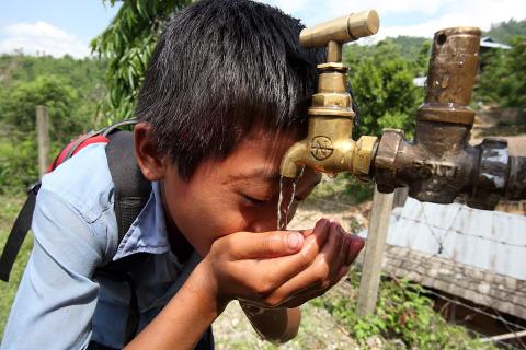 A boy drinks tap water from a tap. The Thai for "a boy drinks tap water from a tap" is "เด็กผู้ชายดื่มน้ำประปาจากก๊อก". A boy drinks tap water from a tap. The Thai for "a boy drinks tap water from a tap" is "เด็กผู้ชายดื่มน้ำประปาจากก๊อก".