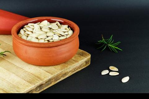Pumpkin seeds in a clay pot. The Thai for "pumpkin seeds in a clay pot" is "เมล็ดฟักทองในหม้อดินเผา". Pumpkin seeds in a clay pot. The Thai for "pumpkin seeds in a clay pot" is "เมล็ดฟักทองในหม้อดินเผา".
