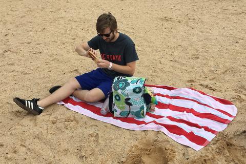 A man having a picnic on the beach. The Thai for "a man having a picnic on the beach" is "ผู้ชายปิกนิกบนชายหาด". A man having a picnic on the beach. The Thai for "a man having a picnic on the beach" is "ผู้ชายปิกนิกบนชายหาด".