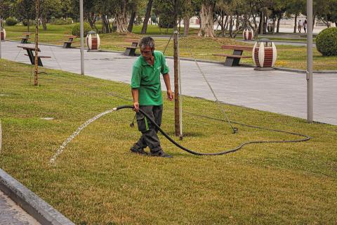 A gardener watering the lawn. The Thai for "a gardener watering the lawn" is "คนสวนรดน้ำสนามหญ้า". A gardener watering the lawn. The Thai for "a gardener watering the lawn" is "คนสวนรดน้ำสนามหญ้า".