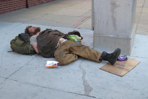 A homeless man sleeping on the street. The Thai for "a homeless man sleeping on the street" is "คนไร้บ้านนอนหลับบนถนน". A homeless man sleeping on the street. The Thai for "a homeless man sleeping on the street" is "คนไร้บ้านนอนหลับบนถนน".