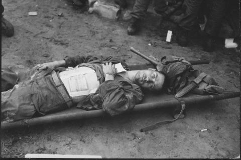 A wounded soldier on a stretcher. The Thai for "a wounded soldier on a stretcher" is "ทหารบาดเจ็บบนเปลหาม". A wounded soldier on a stretcher. The Thai for "a wounded soldier on a stretcher" is "ทหารบาดเจ็บบนเปลหาม".