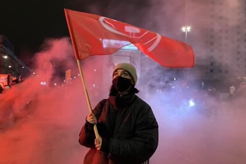 A female protester raises a red flag. The Thai for "a female protester raises a red flag" is "ผู้ประท้วงหญิงชูธงแดง". A female protester raises a red flag. The Thai for "a female protester raises a red flag" is "ผู้ประท้วงหญิงชูธงแดง".