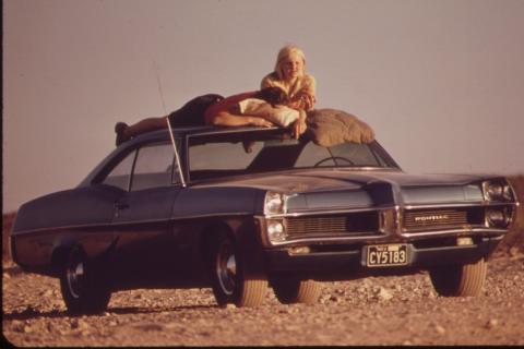 A man and a woman sunbathing on the roof of a car. The Thai for "a man and a woman sunbathing on the roof of a car" is "ผู้ชายและผู้หญิงอาบแดดบนหลังคารถ". A man and a woman sunbathing on the roof of a car. The Thai for "a man and a woman sunbathing on the roof of a car" is "ผู้ชายและผู้หญิงอาบแดดบนหลังคารถ".