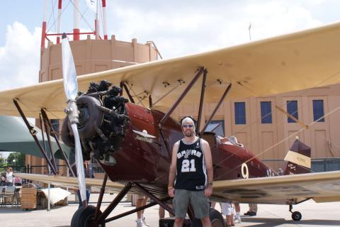 A man standing in front of a small plane. The Thai for "a man standing in front of a small plane" is "ผู้ชายยืนอยู่หน้าเครื่องบินเล็ก". A man standing in front of a small plane. The Thai for "a man standing in front of a small plane" is "ผู้ชายยืนอยู่หน้าเครื่องบินเล็ก".