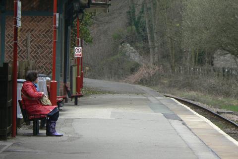 A woman on a bench waiting for the train. The Thai for "a woman on a bench waiting for the train" is "ผู้หญิงบนม้านั่งกำลังรอรถไฟ". A woman on a bench waiting for the train. The Thai for "a woman on a bench waiting for the train" is "ผู้หญิงบนม้านั่งกำลังรอรถไฟ".