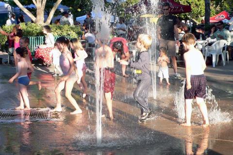 Kids playing in a fountain during a hot summer. The Thai for "kids playing in a fountain during a hot summer" is "เด็กๆเล่นน้ำพุในฤดูร้อน". Kids playing in a fountain during a hot summer. The Thai for "kids playing in a fountain during a hot summer" is "เด็กๆเล่นน้ำพุในฤดูร้อน".