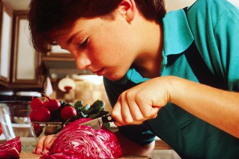 A boy slicing a cabbage. The Thai for "a boy slicing a cabbage" is "เด็กผู้ชายหั่นกะหล่ำปลี". A boy slicing a cabbage. The Thai for "a boy slicing a cabbage" is "เด็กผู้ชายหั่นกะหล่ำปลี".