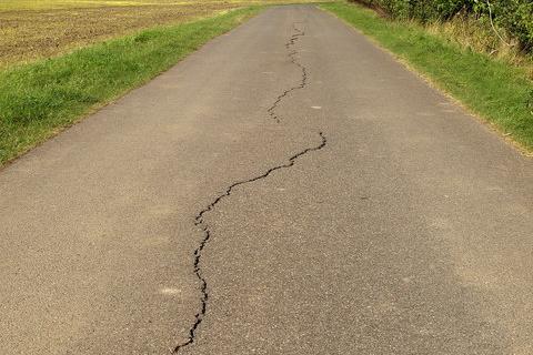 A cracked road. The Thai for "a cracked road" is "ถนนร้าว". A cracked road. The Thai for "a cracked road" is "ถนนร้าว".