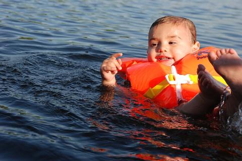 A boy is wearing a life jacket. The Thai for "a boy is wearing a life jacket" is "เด็กผู้ชายใส่เสื้อชูชีพ". A boy is wearing a life jacket. The Thai for "a boy is wearing a life jacket" is "เด็กผู้ชายใส่เสื้อชูชีพ".