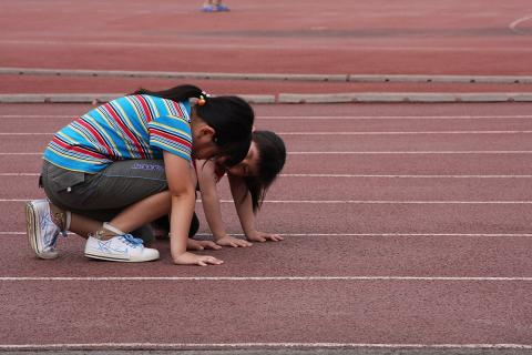 Two girls on a running track. The Thai for "two girls on a running track" is "เด็กผู้หญิงสองคนบนลู่วิ่ง". Two girls on a running track. The Thai for "two girls on a running track" is "เด็กผู้หญิงสองคนบนลู่วิ่ง".