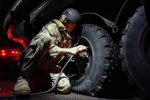 A soldier is inflating a tyre. The Thai for "a soldier is inflating a tyre" is "ทหารกำลังเติมลมยาง". A soldier is inflating a tyre. The Thai for "a soldier is inflating a tyre" is "ทหารกำลังเติมลมยาง".